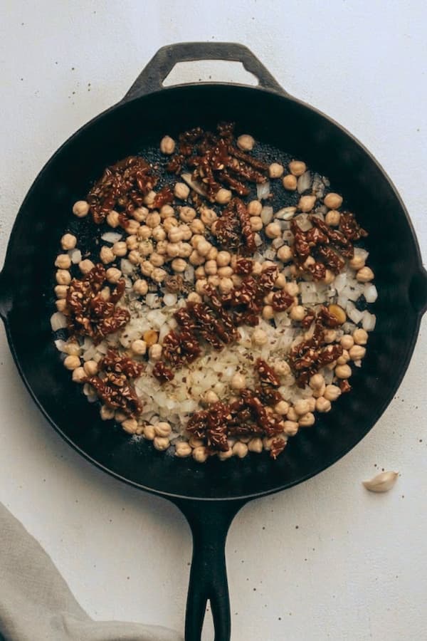 adding chickpeas and tomatoes